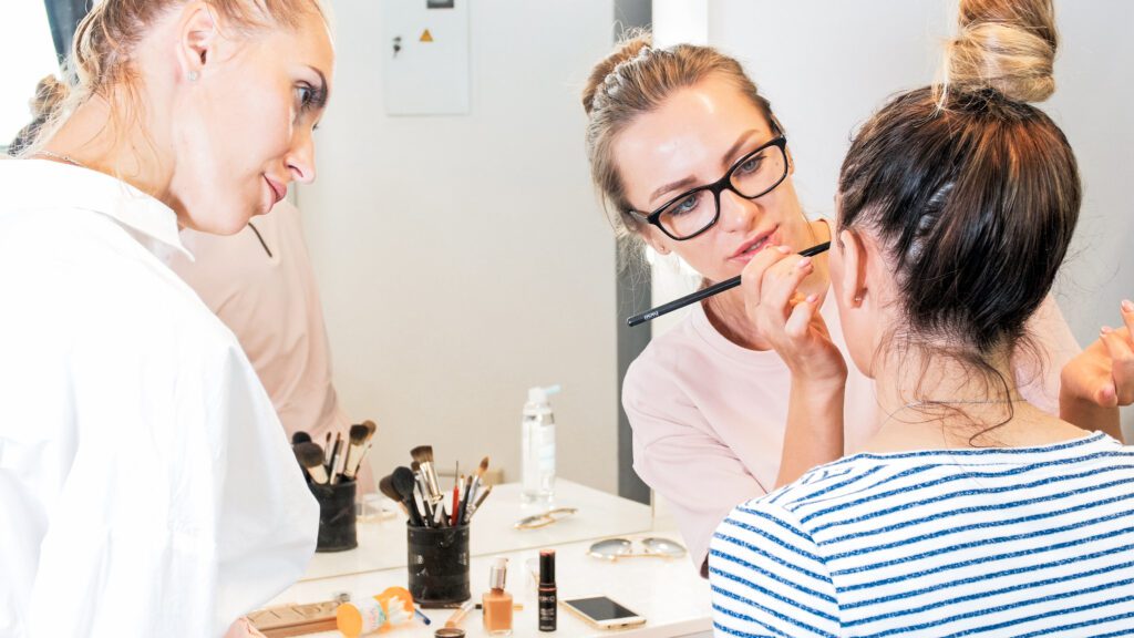 Makeup artist teaching young ones about fashion show